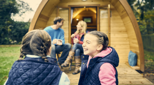 An image of a family outside a whitemead pod